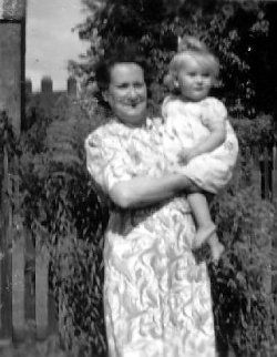 This photograph was taken in
                                September 1947 at 74 Shrewsbury Lane,
                                Shooters Hill, Plumstead and shows my
                                grandmother holding cousin Elizabeth.
                                Elizabeth is the daughter of Winnie and
                                Vic Hind. 